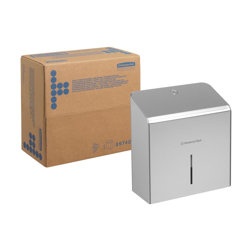 Eine Pappschachtel steht neben einem Kimberly-Clark Professional™ Mini Jumbo Toilettenpapierspender (Edelstahl) der Kimberly-Clark GmbH, der auf der Vorderseite ein kleines vertikales Fenster aufweist.