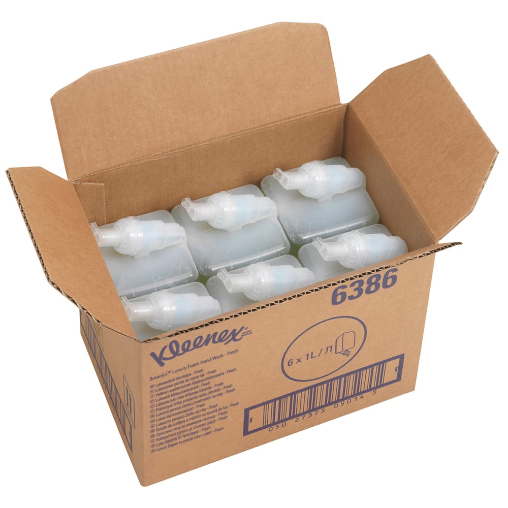 Una scatola aperta con la scritta "Kleenex® Botanics™ Luxury Foam Hand Wash - cassetta da 1L" della Kimberly-Clark GmbH contiene sei cassette verdi da 1L, informazioni e un codice a barre. La scatola mette in risalto il sapone schiumoso con estratti botanici.