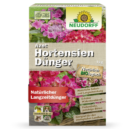Eine 1 kg Kiste Azet HortensienDünger aus dem Neudorff Shop - ein natürlicher Dünger für Gartenhortensien. Die Verpackung zeigt bunte Hortensienblütenkugeln und Produktdetails in deutscher Sprache.