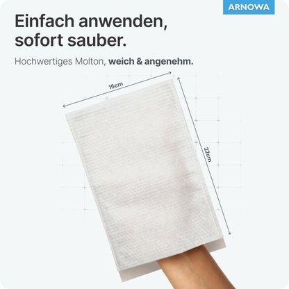 Una mano indossa un guanto da lavaggio monouso ARNOMED bianco in mollettone (15x22 cm) della ARNOWA GmbH, indicato come facile da maneggiare, di alta qualità e delicato per la cura della pelle. Nell'angolo si trovano il sigillo Dermatest e il logo ARNOWA.