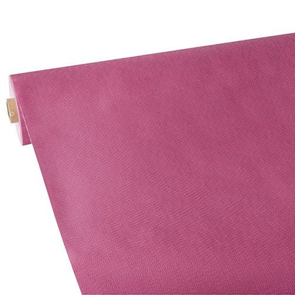 Raffigurato è un rotolo parziale di tovaglia Starpak, simile al tessuto, tessuto non tessuto "soft selection plus" su sfondo bianco, con il materiale rosa monocromatico leggermente srotolato.