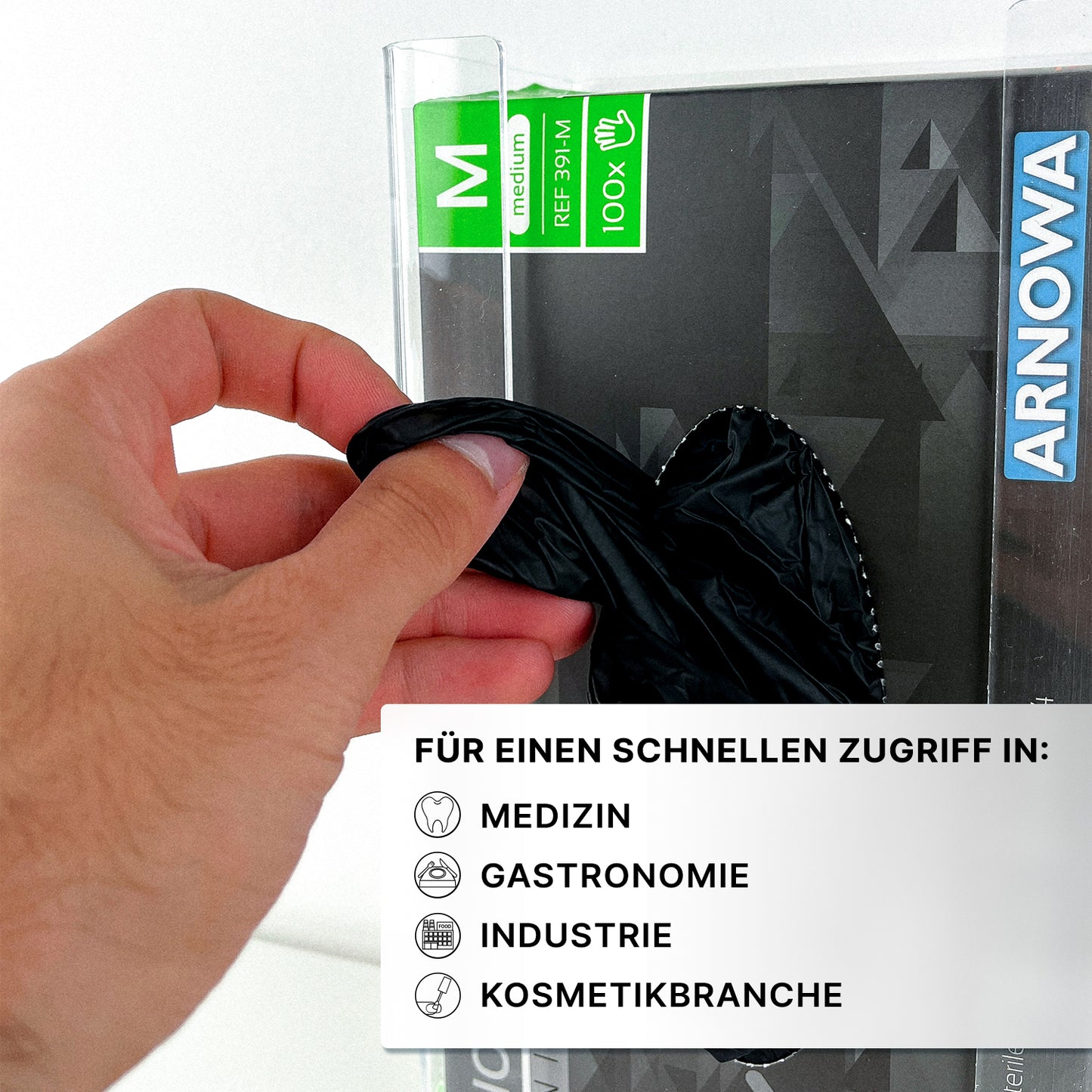 Eine Hand zieht einen schwarzen Handschuh aus dem transparenten ARNOMED Handschuhspender zur 3-fach Befüllung der ARNOWA GmbH - ideal für die Aufbewahrung von Einweghandschuhen in Medizin, Gastronomie, Industrie und Kosmetik.