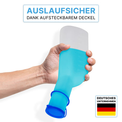 Una mano tiene la bottiglia urinaria ARNOMED ECO Herren di ARNOWA GmbH con tappo trasparente igienico; in alto il testo tedesco evidenzia il design a prova di perdite, in basso a destra è visibile il logo ARNOWA con la bandiera tedesca.