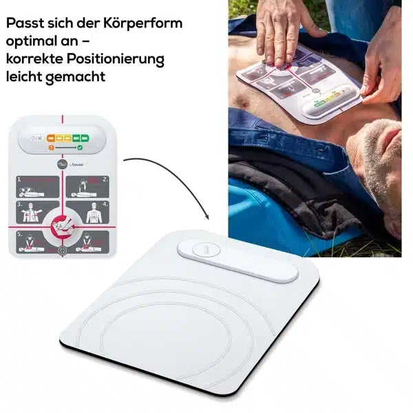 Eine Nahaufnahme zeigt eine Person, die im Freien liegt, während jemand einen innotas Auslaufartikel anlegt: Beurer LifePad® Reanimationshilfe (1 Stück) auf die Brust. Das Bild zeigt auch ein Diagramm zur korrekten Platzierung des Pads.