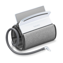 Un bracciale universale arrotolato Beurer per sfigmomanometro BM 51 con bracciale collegato a un monitor digitale bianco. Dal bracciale universale parte un tubo flessibile che termina in un raccordo per il collegamento a un dispositivo di misurazione. Lo schermo del monitor leggermente inclinato è parzialmente visibile. Adatto per circonferenze del braccio da 22 a 42 cm.