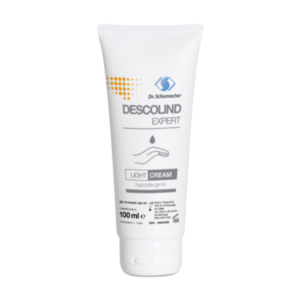 Eine 100-ml-Tube Descolind Expert Light Cream Handcreme von Dr. Schumacher GmbH. Die weiße Tube ist mit blauem und grauem Text versehen, mit einer Tropfengrafik über dem Produktnamen. Diese hypoallergene Pflegecreme wurde speziell mit Sheabutter für empfindliche Haut formuliert.