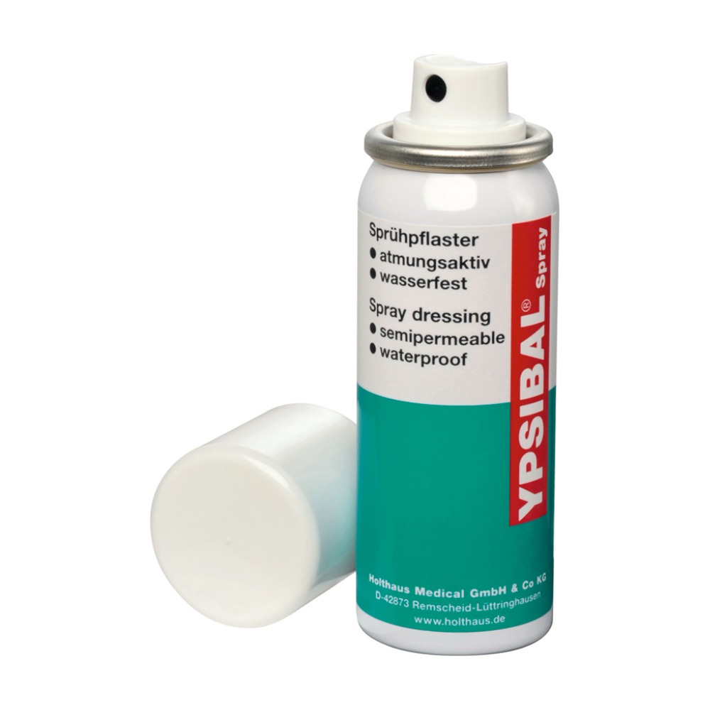 Una bomboletta spray di Holthaus Ypsibal® Spray, cerotto spray - 50 ml di Holthaus Medical GmbH & Co. KG viene fornita senza tappo bianco e appoggiata alla base. Il testo sulla confezione prevalentemente bianca con sezioni blu-verdi e accenti rossi indica che si tratta di una benda spray semipermeabile, impermeabile e traspirante per tagli e abrasioni.
