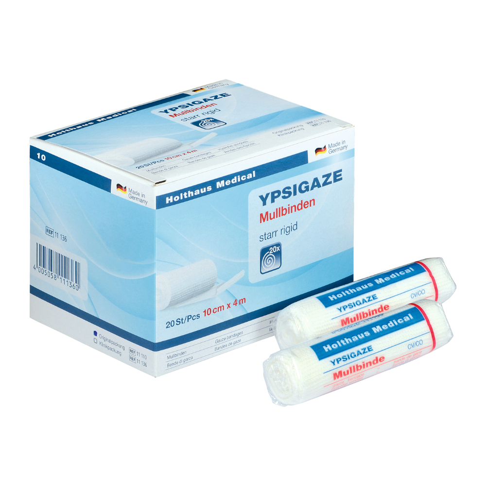 Oltre a due rotoli singoli, è esposto un cartone con la benda di garza Ypsigaze di Holthaus Medical GmbH & Co. KG. La benda rigida è di 10 cm x 4 m e contiene 20 pezzi.