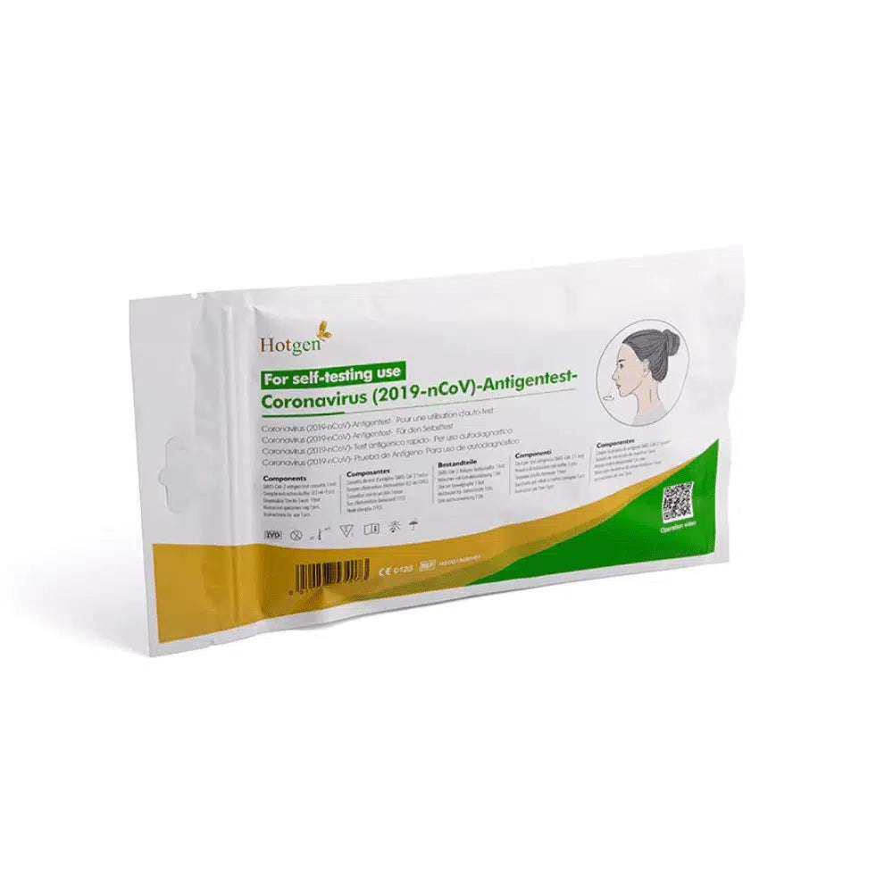 Una confezione con la scritta „Hotgen Sars-CoV-2 Antigen Laien Schnelltest CE0123 | Confezione (1 Test)“ per l'autotest presenta accenti verdi e arancioni e mostra un'immagine di una persona. La scritta „Hotgen“ è chiaramente visibile nell'angolo in alto a sinistra e identifica il test come un test antigenico SARS-CoV-2.