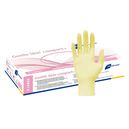 Un guanto in lattice giallo è visibile davanti a uno sfondo con una scatola di guanti monouso Meditrade Gentle Skin® Latexhandschuhe compact+ con la scritta „senza polvere“ per la lavorazione degli alimenti. La scatola è parzialmente aperta e offre una vista di altri guanti della Meditrade GmbH.