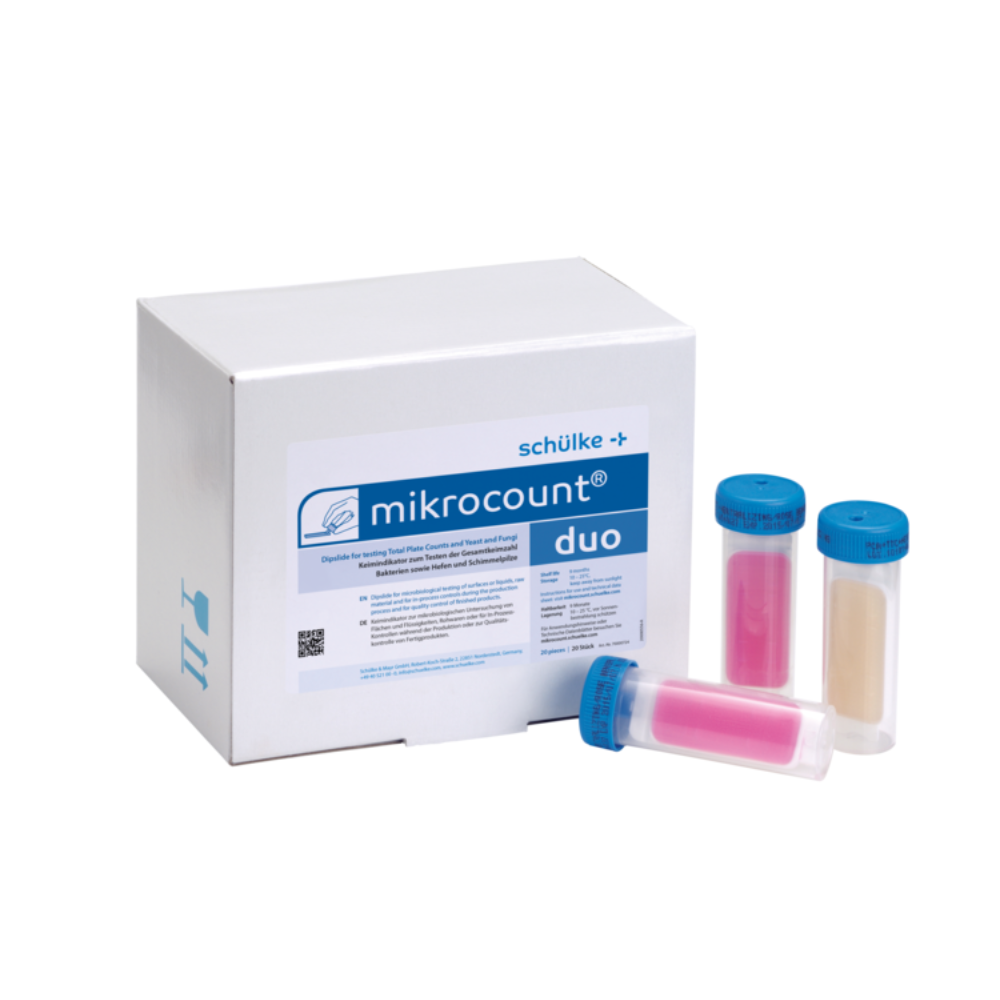 L'immagine mostra una scatola con la scritta „Schülke mikrocount® duo, indicatore di germi | Confezione (20 pezzi)“ del marchio „Schülke & Mayr GmbH“ accanto a tre provette codificate a colori con tappi blu. Le provette contengono sostanze rosa e beige, utilizzate per rilevare microrganismi su superfici e liquidi, inclusi lieviti e muffe.