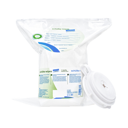 Una confezione di salviette Schülke & Mayr GmbH Schülke wipes safe&easy imbevute di disinfettante per superfici in un dispenser di plastica trasparente con coperchio a scatto. L'etichetta contiene testo e un simbolo a croce verde che indica l'uso come dispositivo medico.