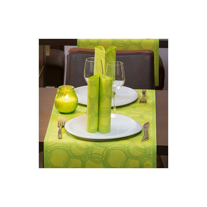 Un tavolo da pranzo è elegantemente apparecchiato per due persone con piatti bianchi, bicchieri a stelo e posate. I tovaglioli verdi sono artisticamente posizionati sui piatti. Un portacandele verde si trova su un PAPSTAR runner da tavola simile a tessuto PV-Tissue Mix "ROYAL Collection" di PAPSTAR GmbH, il cui motivo circolare conferisce raffinatezza alla scena.