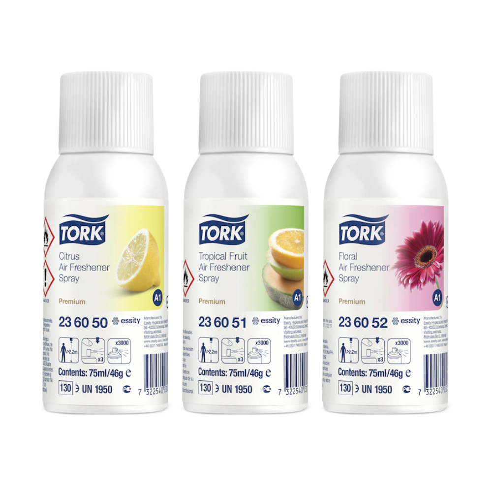 Drei Tork 236056 Lufterfrischer Sprays im Mixed Pack (Citrus, Tropical Fruit, Floral) mit passenden Motiven auf weißem Etikett – ideal zur Geruchsneutralisierung und anhaltende Frische. Karton enthält 12 Flaschen.