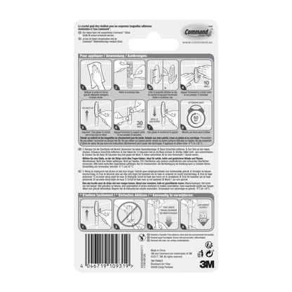 Die Rückseite einer Command™ Bad Medium Designer-Haken, 17081B von 3M Deutschland GmbH-Verpackung zeigt illustrierte Auf- und Abbauschritte, mehrsprachigen Text, Sicherheitswarnungen und einen Barcode am unteren Rand.