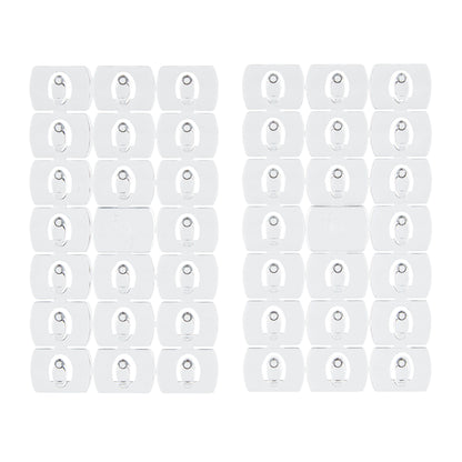 Zwei Packungen mit 24 Command™ Dekorations-Clips, transparent mit transparenten Streifen, von 3M Deutschland GmbH, dargestellt in einem Gittermuster auf weißem Hintergrund.